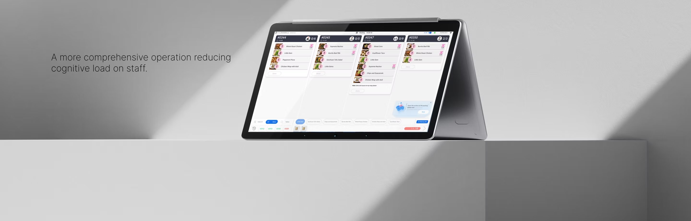The tablet form-factor of Packing Order Accuracy, sitting on a counter in a working kitchen.