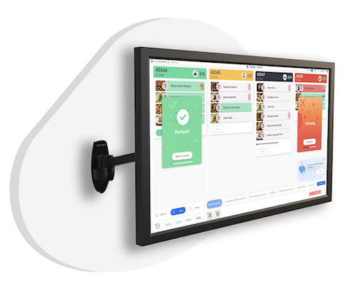 The wall-mounted Packing dashboard on its real bracket, angled into the kitchen, showing the four-order surface with a Perfect! confirmation and a 1 Missing recovery card mid-shift.